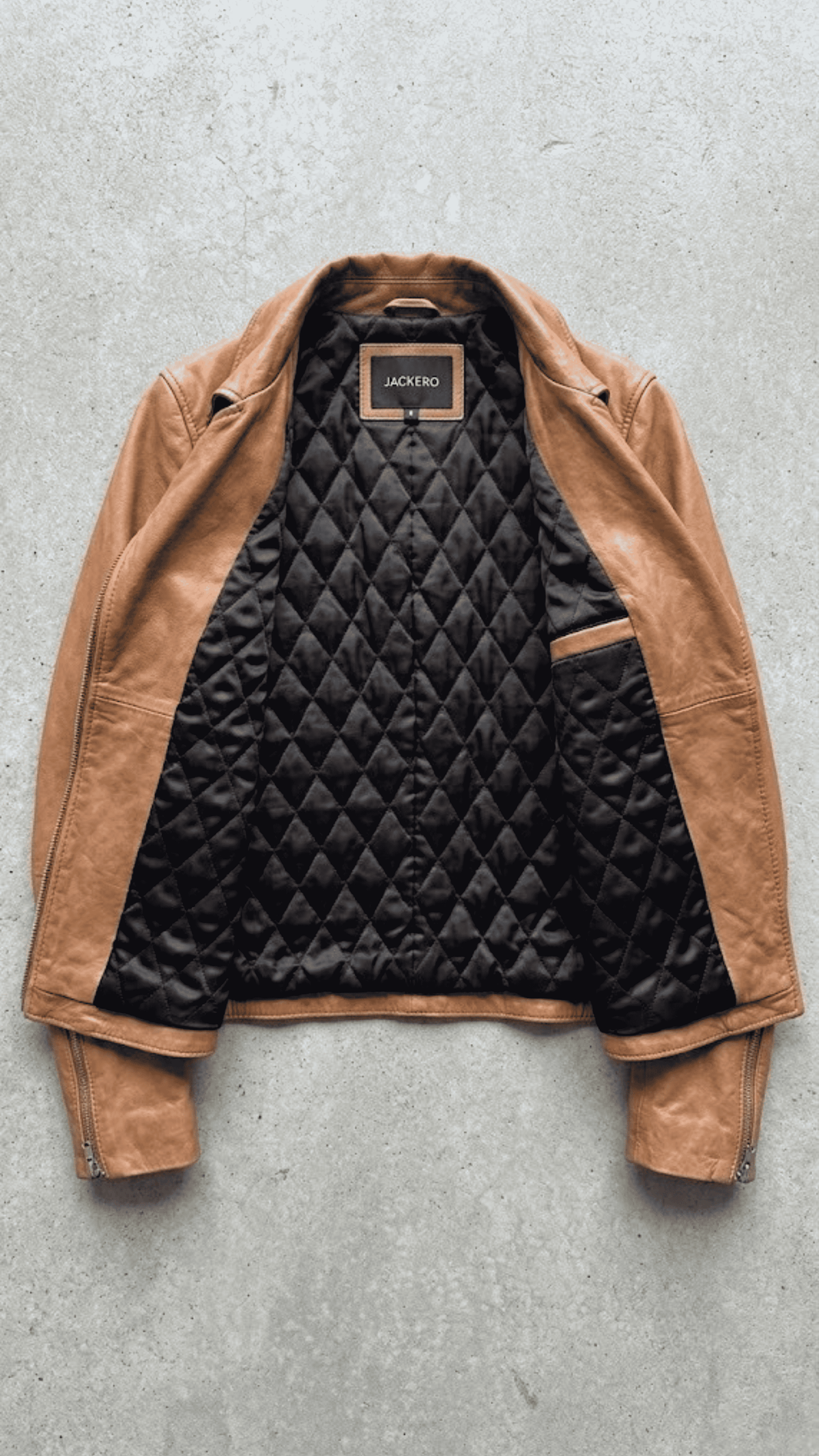 Jackero jacket flat lay presentation featuring the contemporary camel brown leather rider jacket neatly displayed on a neutral background.