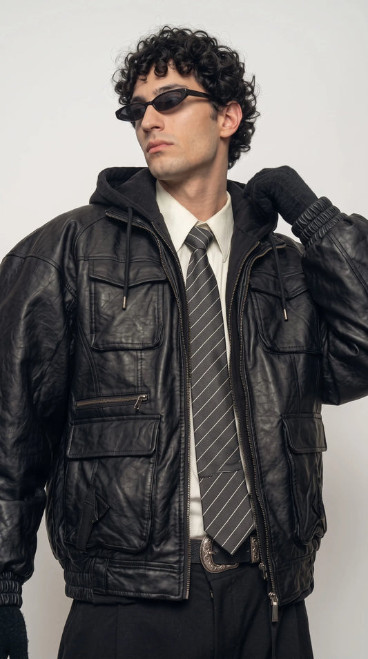 Rear view of a black leather hoodie jacket for men with the hood lying flat, showing smooth back panelling and a clean modern silhouette