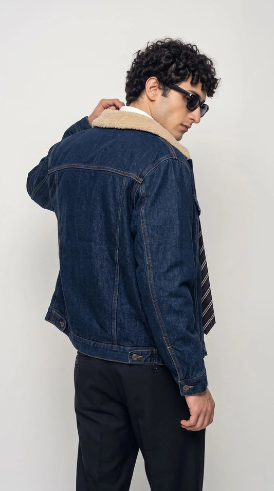 An engaging Jackero deep blue jean coat tailored for the modern urban explorer, combining rugged dark indigo denim with a cozy sherpa collar for the ultimate streetwear aesthetic.