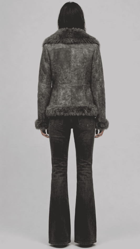 Model wearing a JACKERO fitted grey fur-trimmed shearling coat paired with a white crop top and high-waisted black flare jeans.
