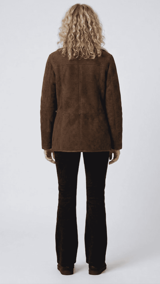 Regular fit dark chocolate brown suede outerwear styled over a dark turtleneck sweater for an elegant winter look.