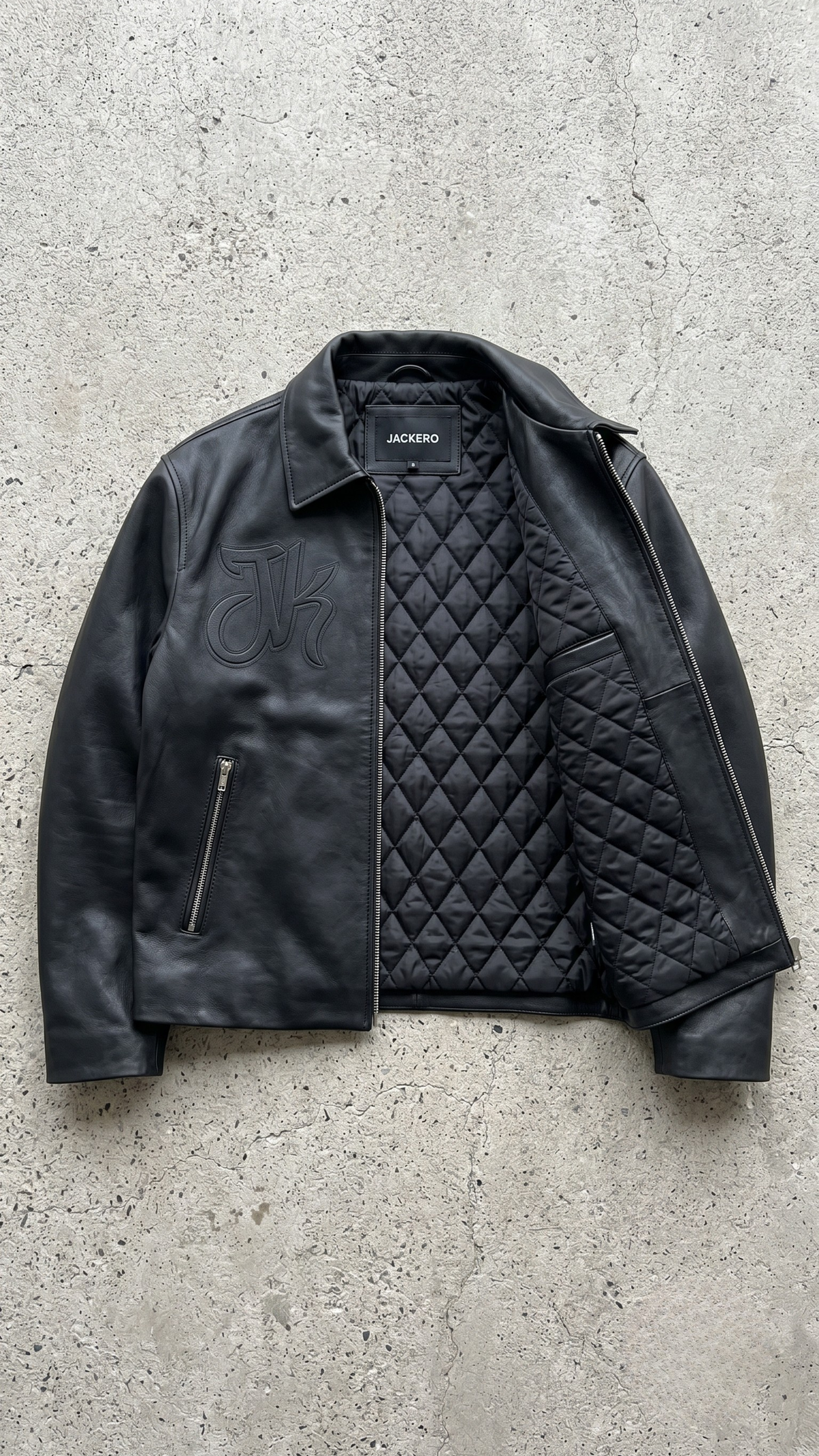 Handcrafted dark black leather harrington bomber jacket by JACKERO, presented with commercial lookbook lighting on a clean grey background.