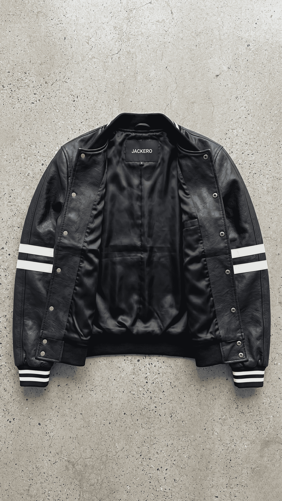the premium black leather cafe racer jacket on a solid grey backdrop.