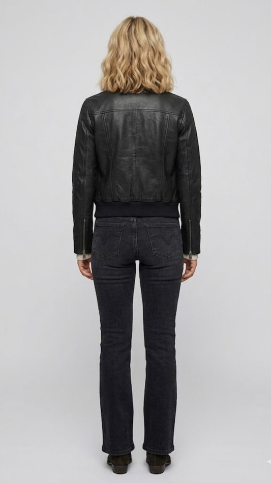 The back perspective of a women's classic black leather bomber jacket, highlighting the clean shoulder tailoring and structured design.