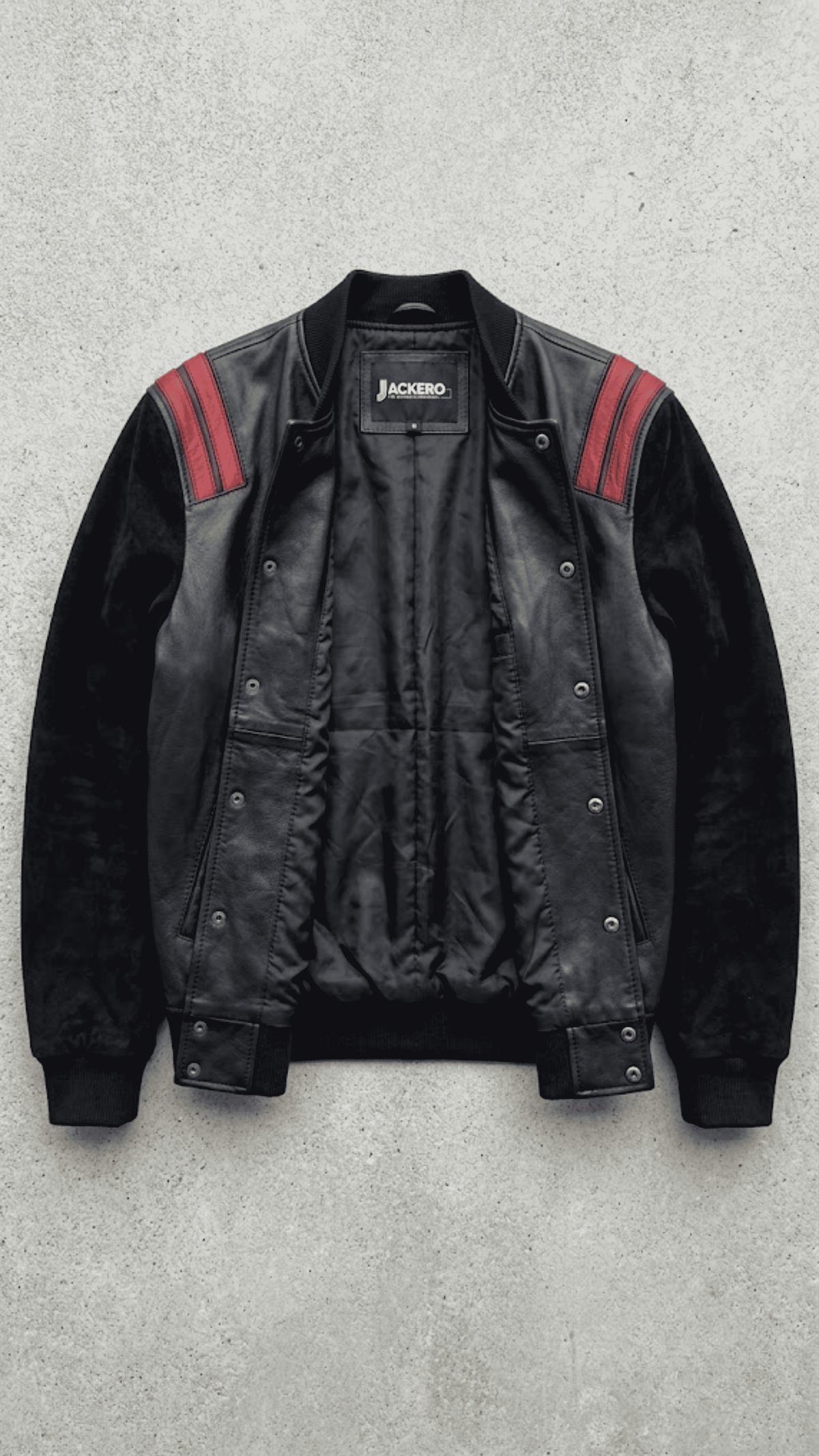 Jackero black and red leather bomber outerwear beautifully presented against a clean, minimalist studio backdrop.