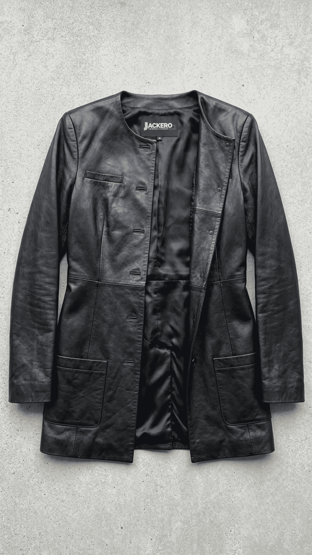 Jackero contemporary long-line black leather trench coat beautifully presented against a clean, professional studio backdrop.