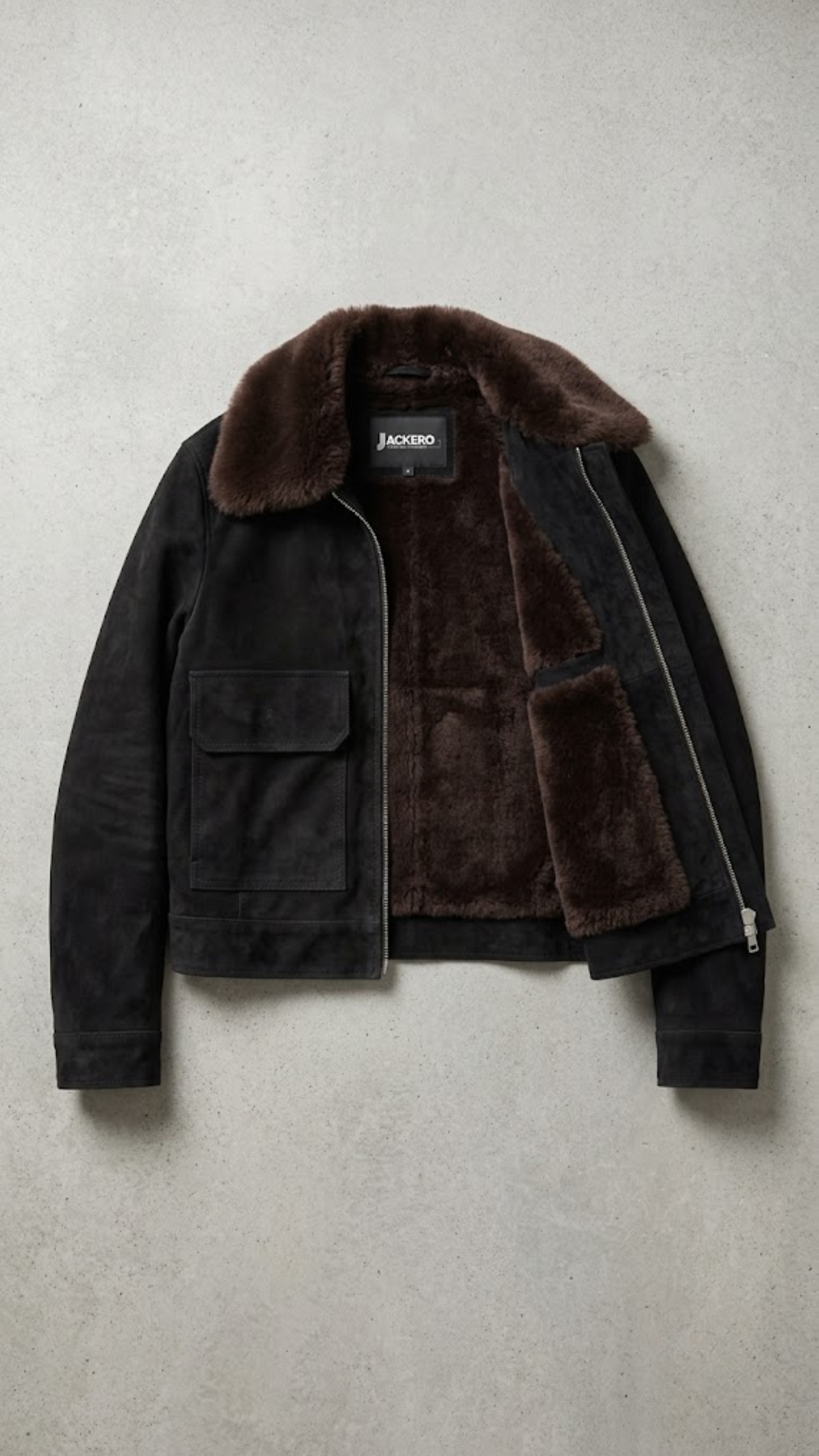 Jackero contemporary dark black suede jacket with dark chocolate shearling beautifully presented against a clean, minimalist studio backdrop.