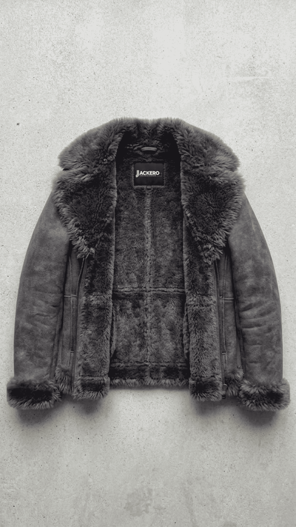 Jackero contemporary dark grey suede jacket with dark grey faux shearling beautifully presented against a clean, minimalist studio backdrop.