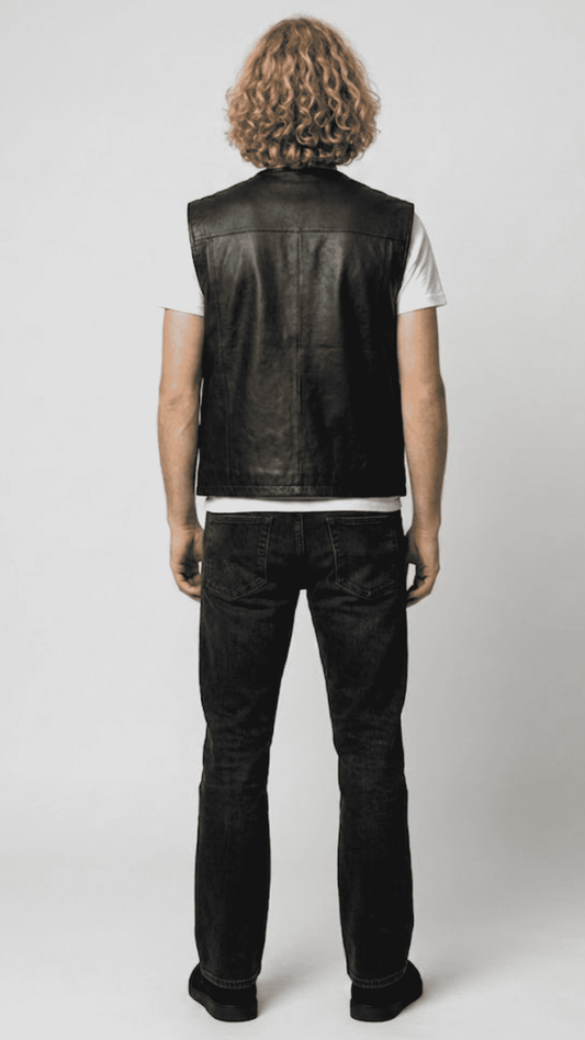 Regular fit men's black leather gilet displaying clean lines, functional front pockets, and a comfortable tailored alignment.