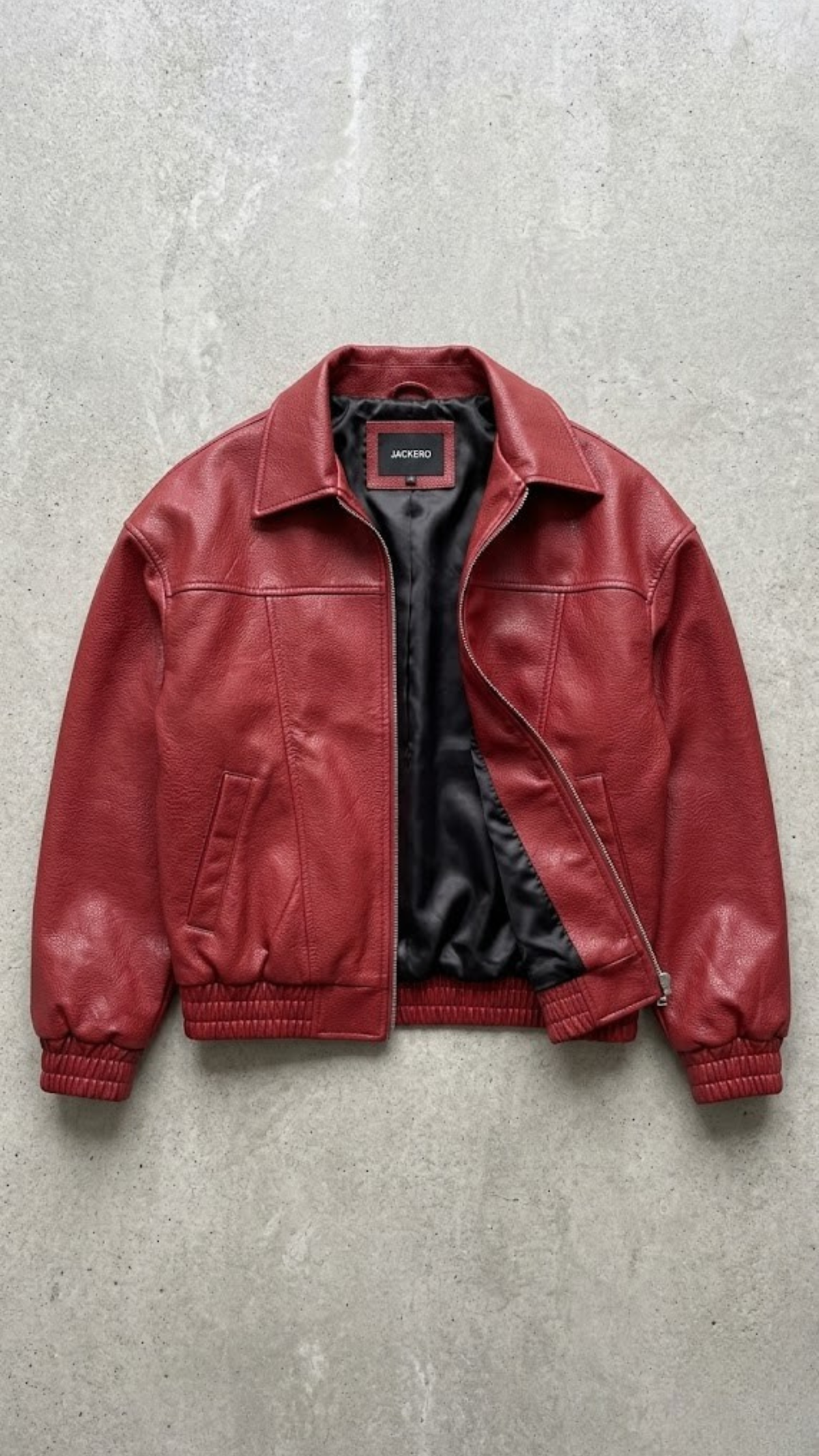 Premium streetwear fashion lookbook featuring a high-quality red leather bomber jacket with front zipper.