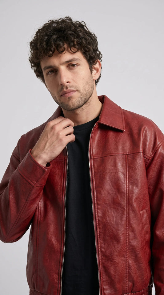 Close-up of a red leather sleeve with a gathered elastic cuff, shown against a solid gray background.
