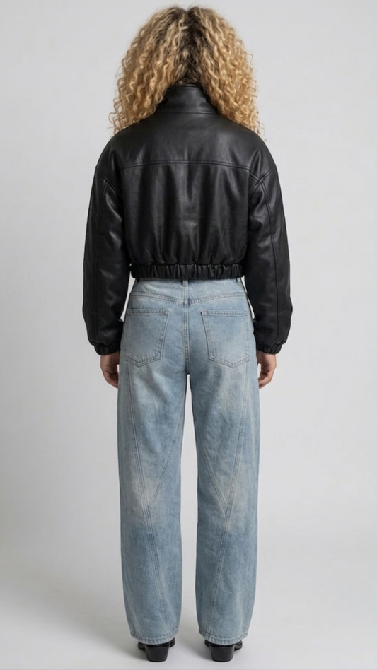 back-angle profile view of a regular fit cropped black leather outerwear showing clean back construction and a sharp, elevated silhouette.