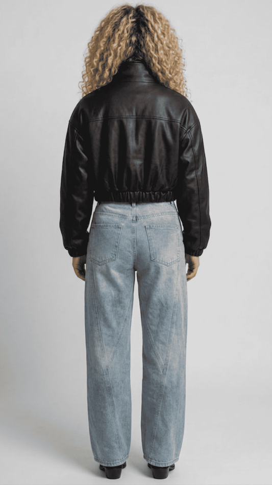 back-angle profile view of a regular fit cropped black leather outerwear showing clean back construction and a sharp, elevated silhouette.