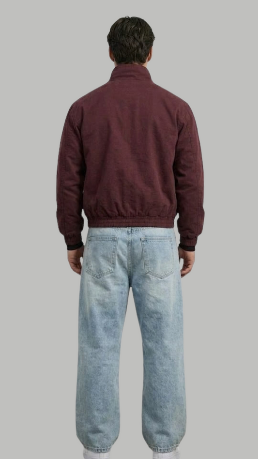 a minimalist deep maroon cotton jacket with simple cuffs.