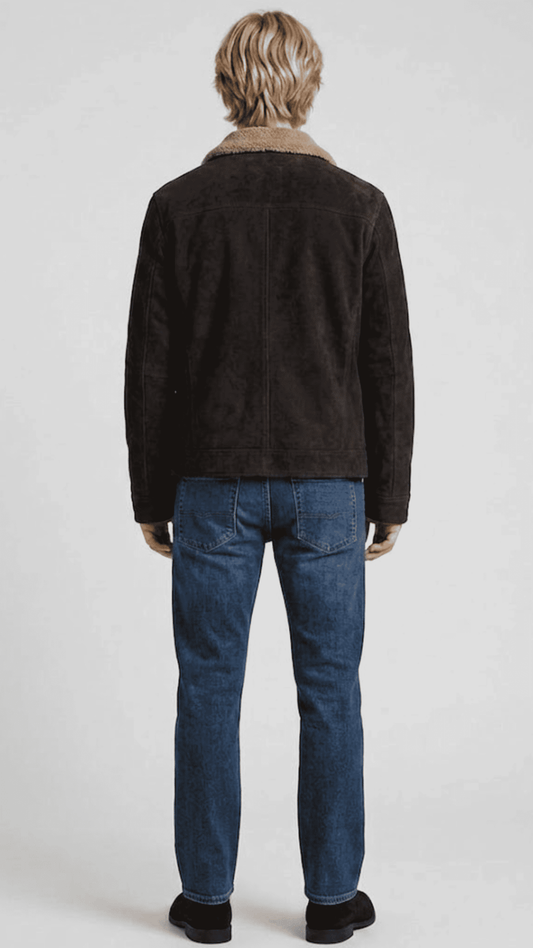 Regular fit dark brown suede shearling jacket layered over a casual knitted sweater for a modern urban aesthetic.