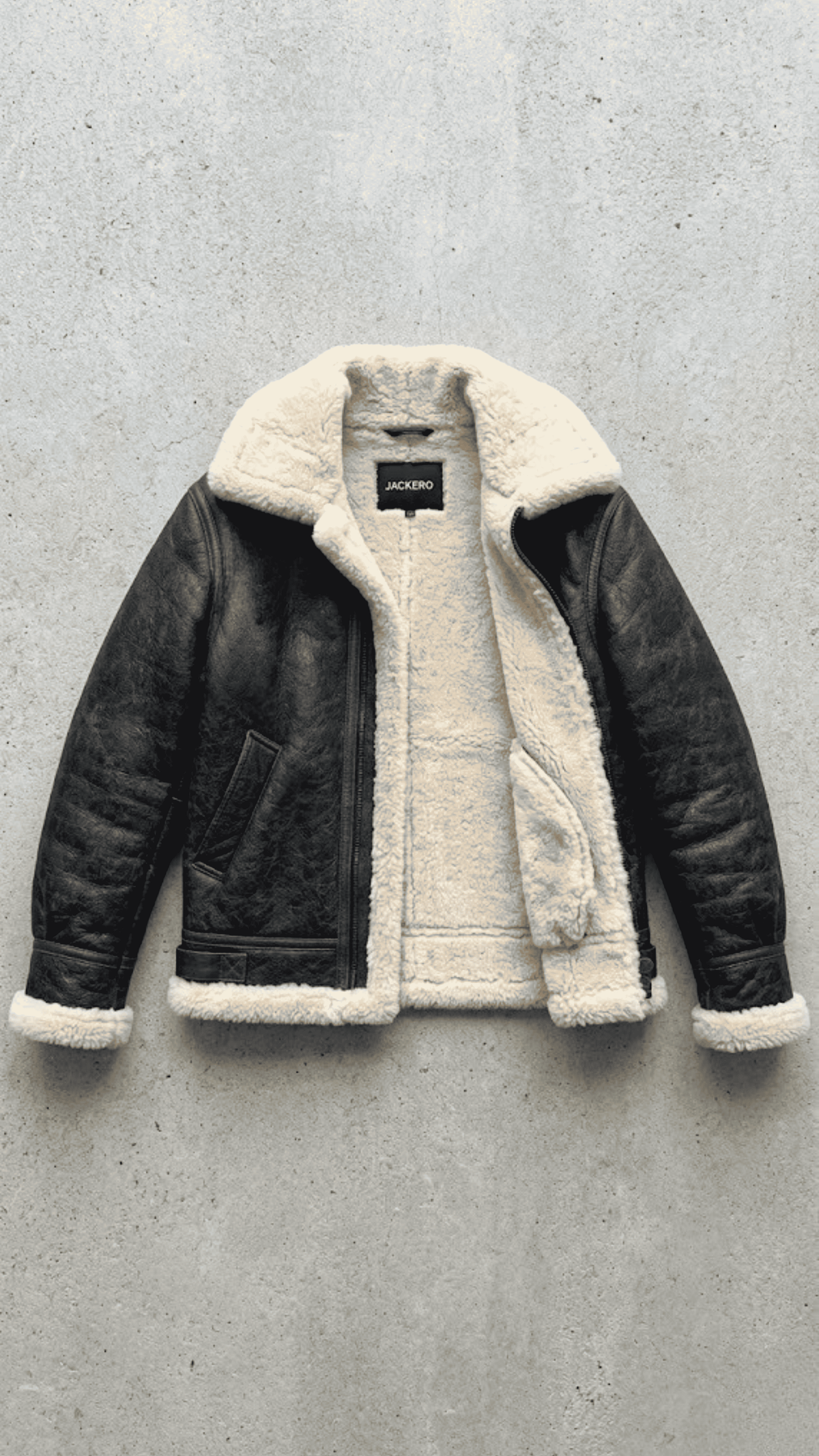 the heavy-duty metal zipper integrated seamlessly with the premium black leather and cream fur inner lapel.