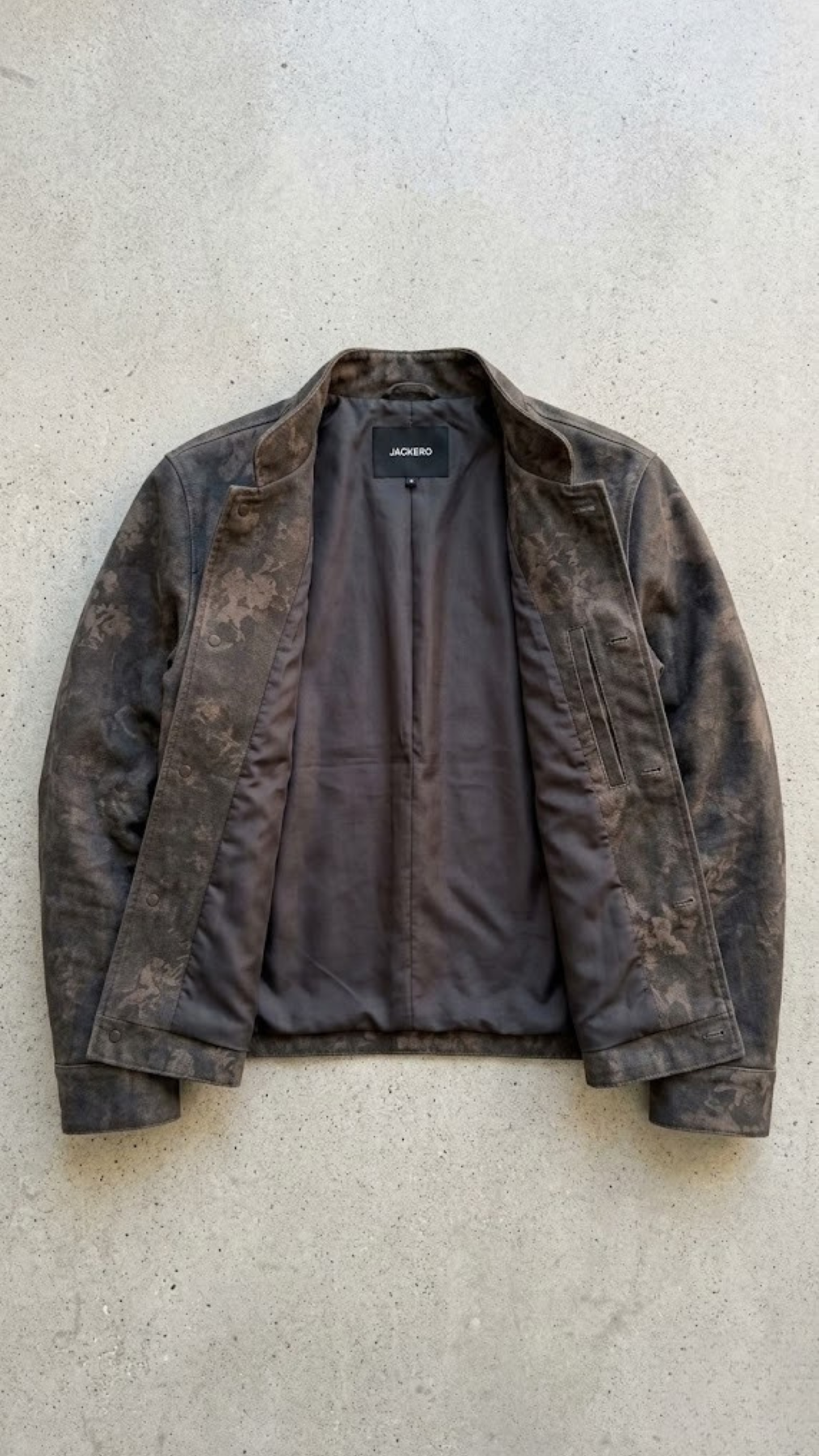 Flat lay view of Jackero premium distressed charcoal leather outerwear on light background