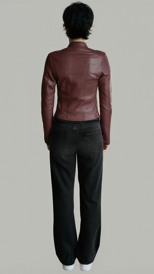Person wearing a dark burgundy leather jacket and black pants on a plain background