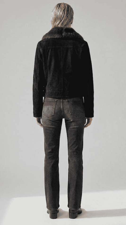 Detailed view of the dark chocolate faux shearling trims exposed beautifully at the cuffs and waistline hem of a premium black suede jacket.