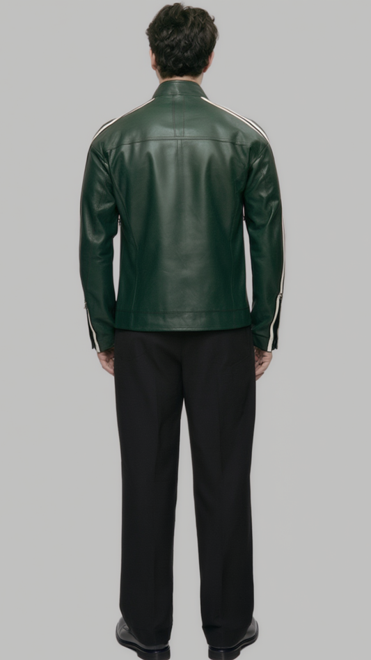 A man viewed from the back wearing a dark green leather jacket with white stripes on the shoulders and sleeves, paired with black trousers, against a solid gray background.