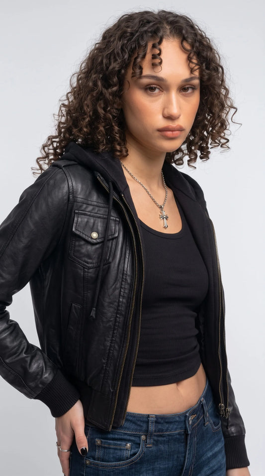 Smooth black genuine leather hooded bomber featuring a buttoned chest flap pocket, contrast metal zipper teeth, stitched leather panels and an adjustable cotton-blend hood, combining functional utility details with contemporary designer-inspired fashion.