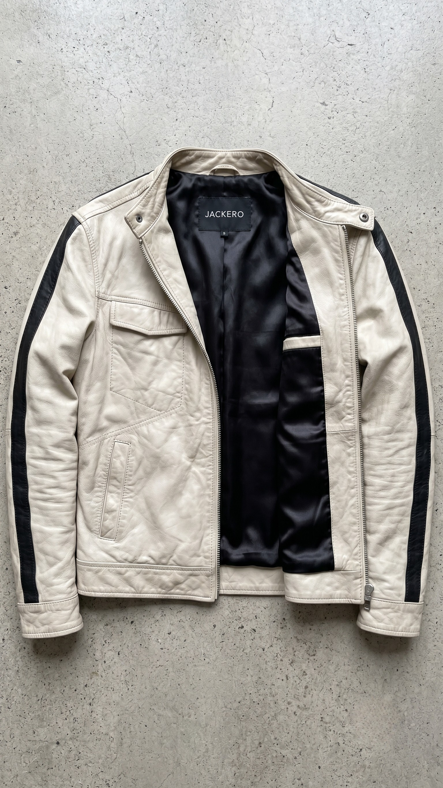 clean contemporary alabaster motorcycle jacket neatly displayed on a contrasting surface.