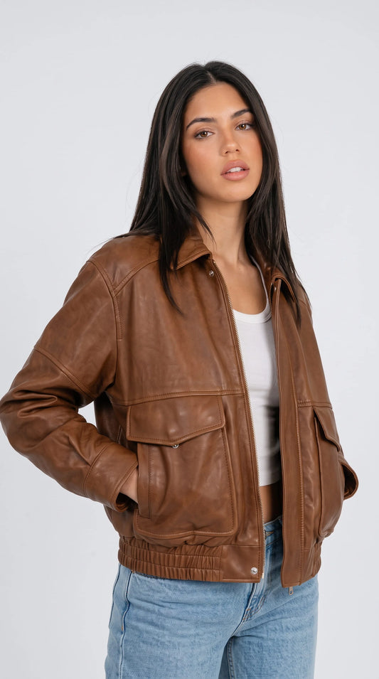 Women's cognac brown vintage leather aviator jacket with soft distressed finish, turn-down collar, button flap pockets and gold zipper, classic pilot style leather outerwear for winter