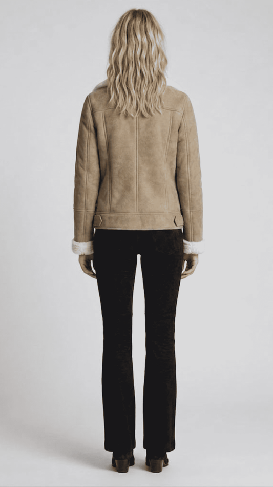 Regular fit beige suede shearling jacket layered over a casual knitted sweater for a modern urban aesthetic.