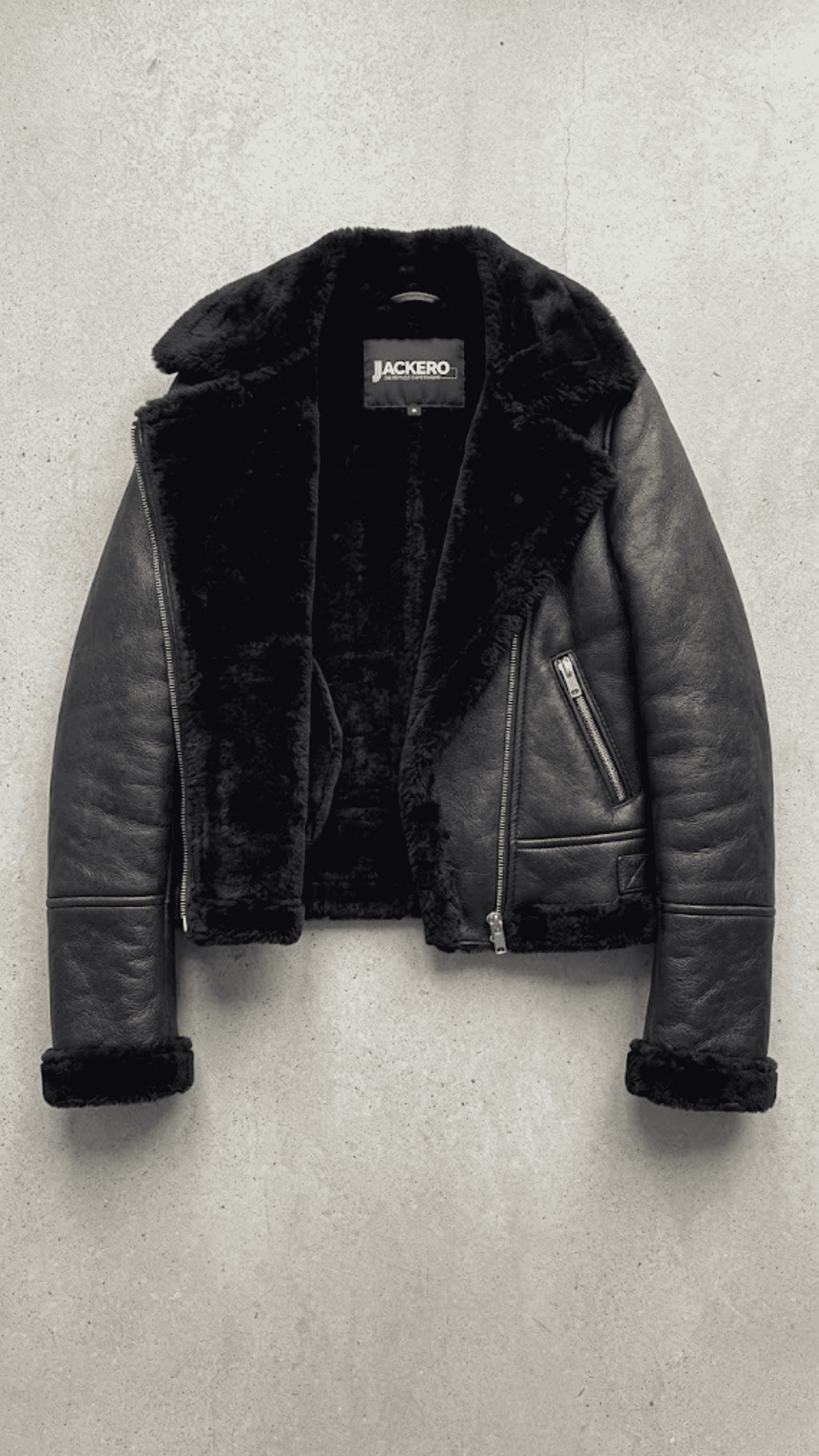 symmetrical jacket lookbook photography of a women's black leather coat with a distinctive shearling collar.