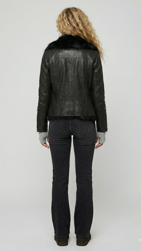 Rear view of the women's black leather biker jacket showing clean stitching and a structured fit with the faux fur collar visible.