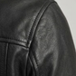 Detailed shot of high-quality stitching, premium hardware, and textured genuine black leather on a classic biker jacket silhouette.
