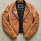 Jackero jacket flat lay presentation featuring the contemporary chestnut brown leather rider jacket neatly laid out on a neutral studio backdrop.