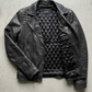black motorcycle jacket perfectly displayed on a high-contrast background.