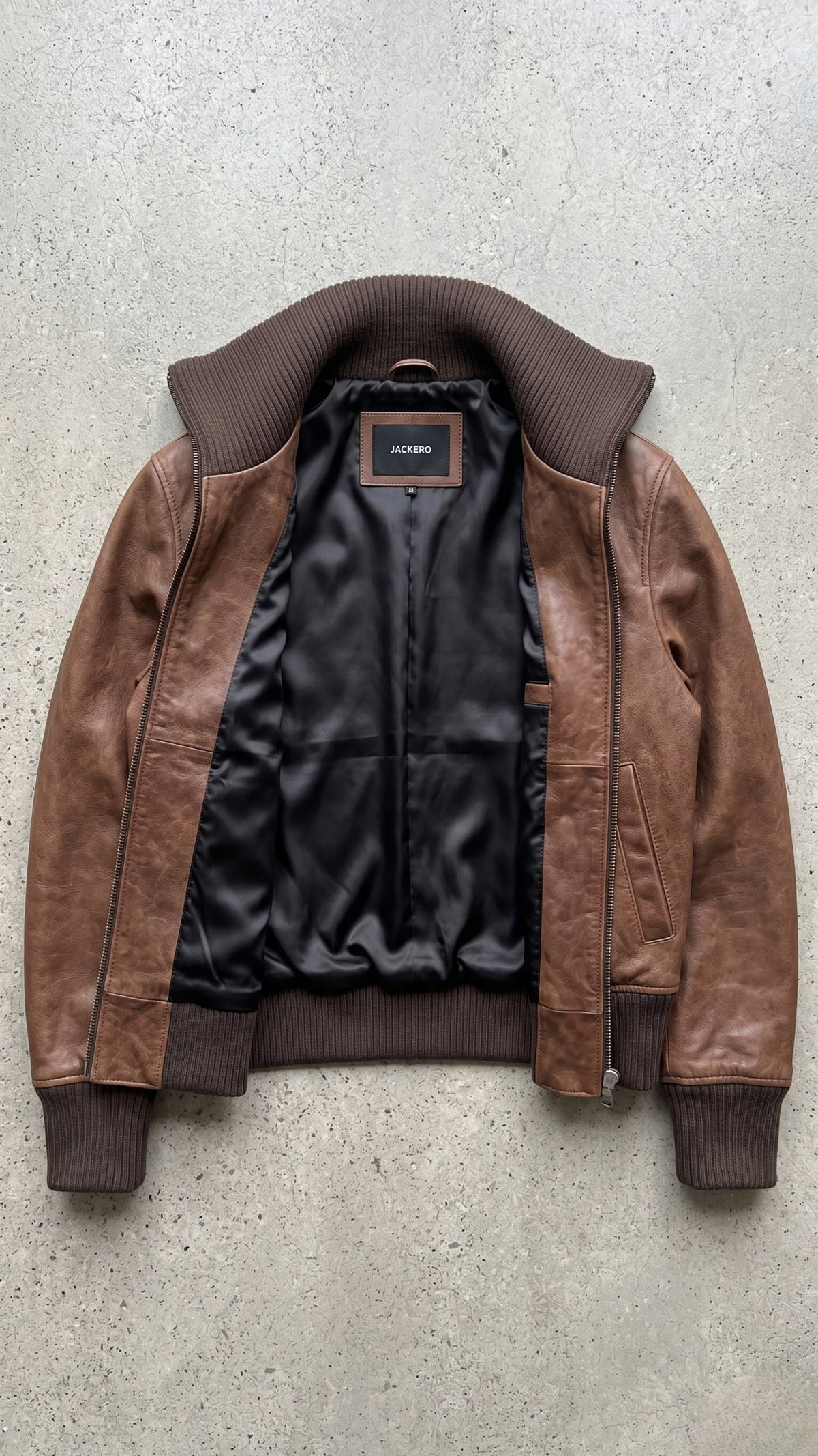 flat lay presentation featuring the luxury dark walnut brown leather bomber jacket arranged neatly on a crisp layout.