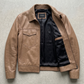 flat lay merchandising display featuring the light tan beige leather bomber jacket neatly arranged on a clean background.