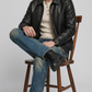 Minimalist black crocodile leather outerwear with high-quality zipper and simple cuffs.
