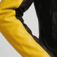 Close-up shot of the high-contrast yellow leather stripes and premium heavy-duty zippers on a black biker jacket.