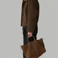 A male model styling a classic autumn look featuring Jackero's premium dark brown utility jacket with a warm, fluffy shearling collar.