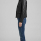 Side angle profile view highlighting the classic adjustable button waist tabs and clean shirt-style cuffs of the black leather outerwear.
