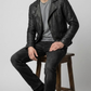 Premium men's style lookbook editorial showcasing a sharp monochromatic street outfit centered around a luxury stealth black rider coat.