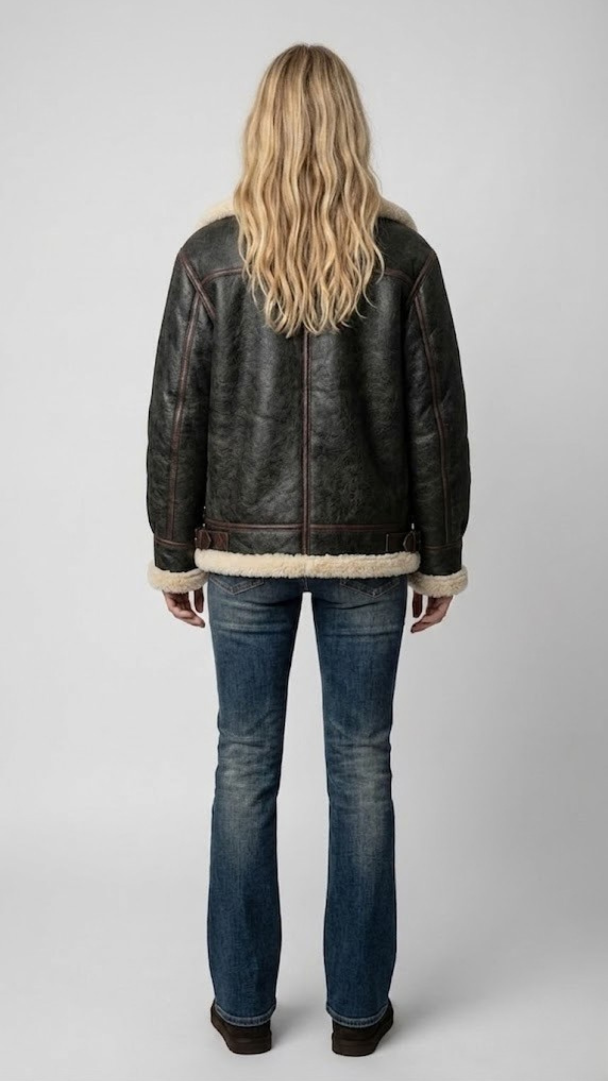 Back panel view of the Jackero premium leather jacket, showcasing tailored fit and the visible cream shearling collar edges.
