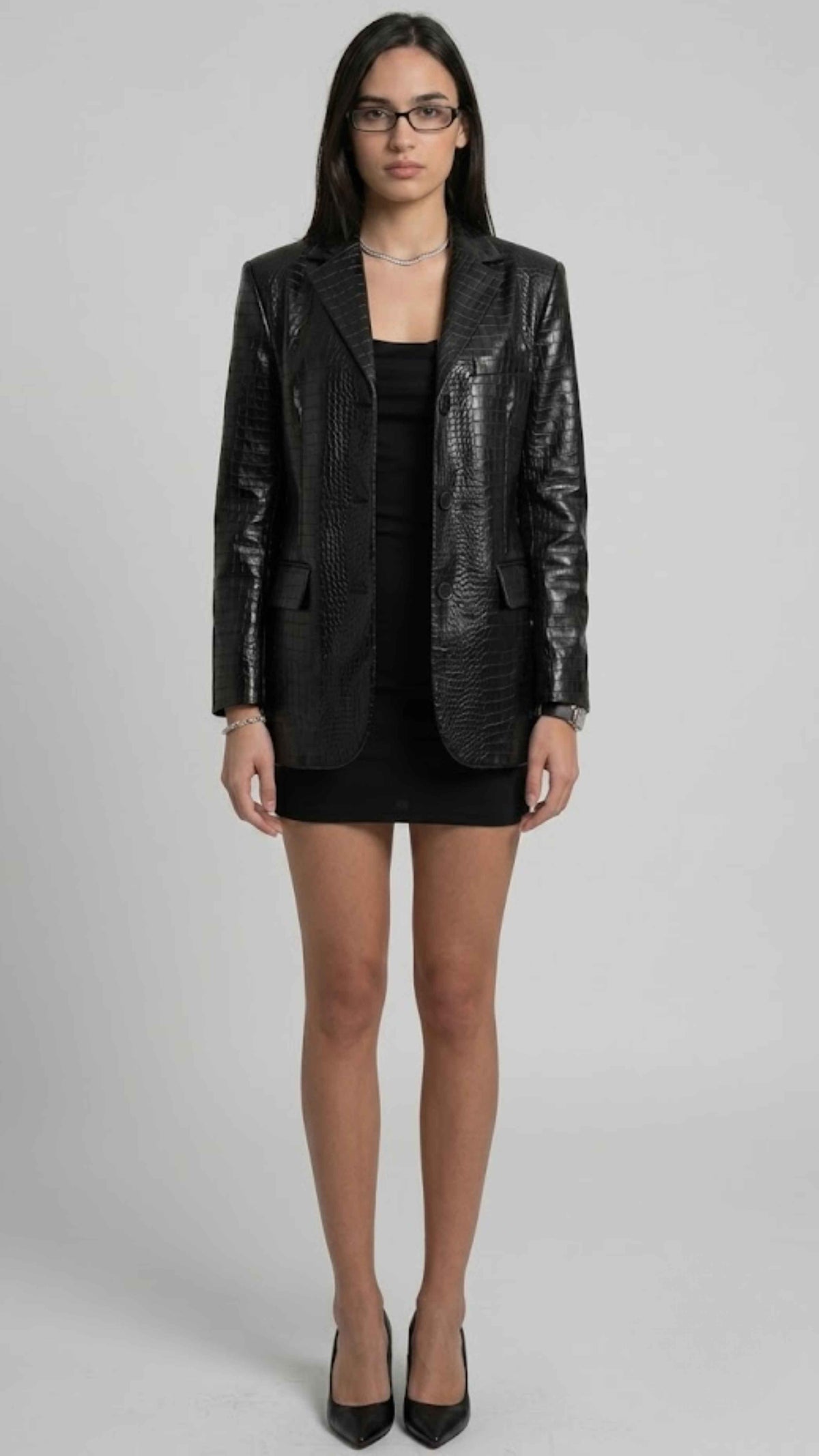 model wearing a jackero black crocodile embossed leather blazer with single breasted button closure
