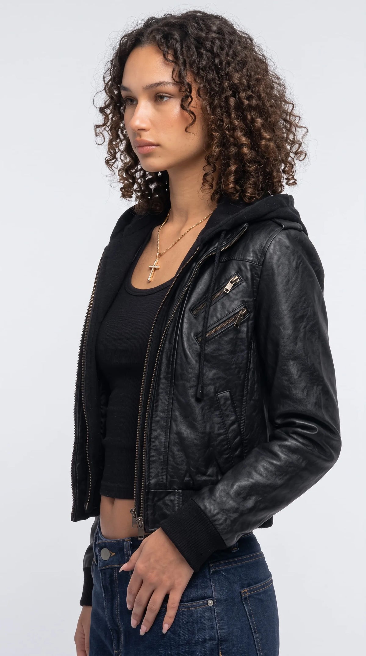 Black leather hooded bomber jacket with diagonal silver-tone chest zippers, an integrated drawstring hood, clean vertical panel stitching and a fitted ribbed cuff, creating an edgy technical streetwear aesthetic with biker-inspired detailing.