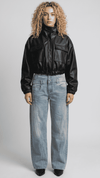 Front full view of premium black leather cropped jacket highlighting the modern short waist-length cut and clean zipper closure.