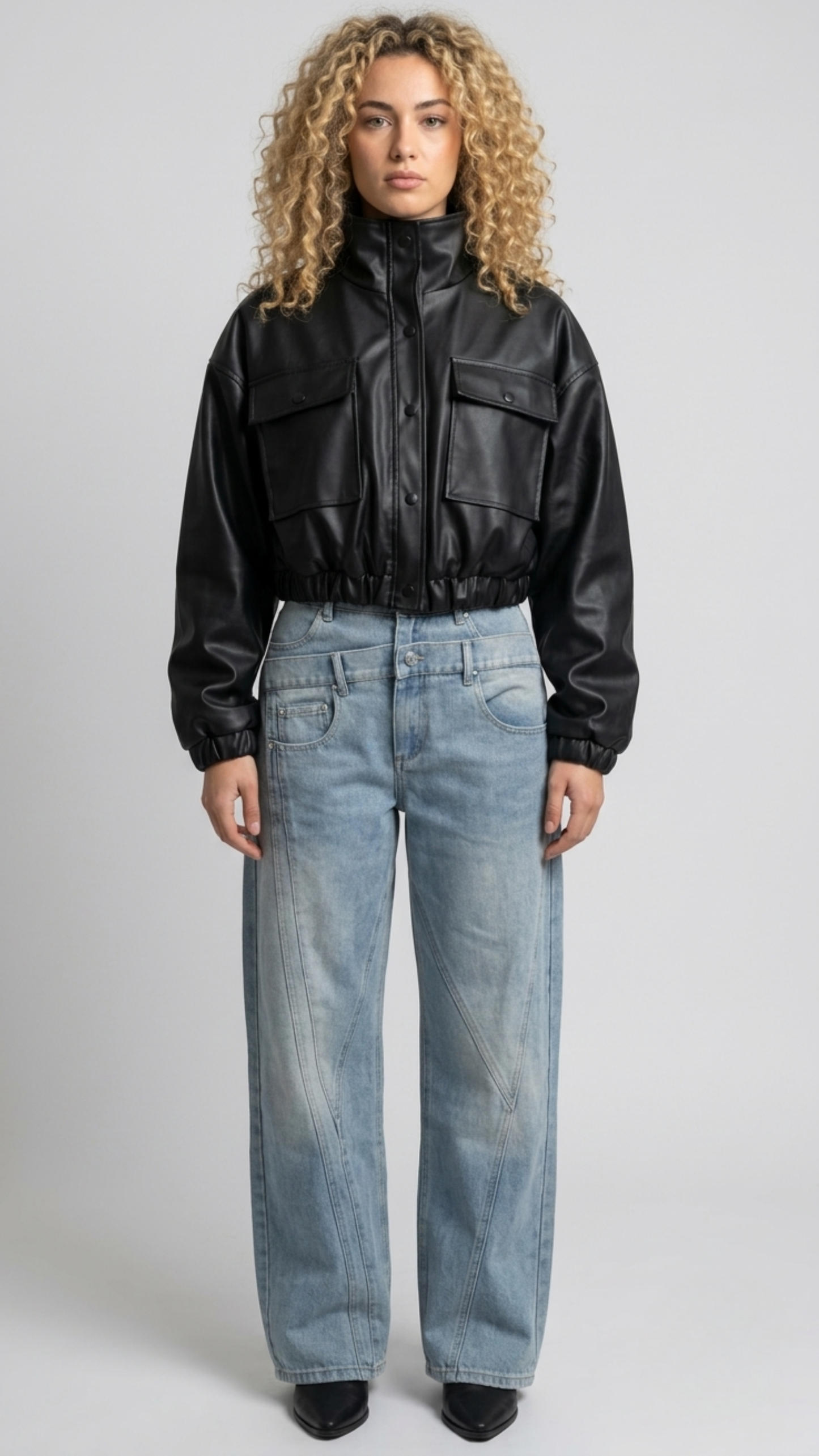Front full view of premium black leather cropped jacket highlighting the modern short waist-length cut and clean zipper closure.