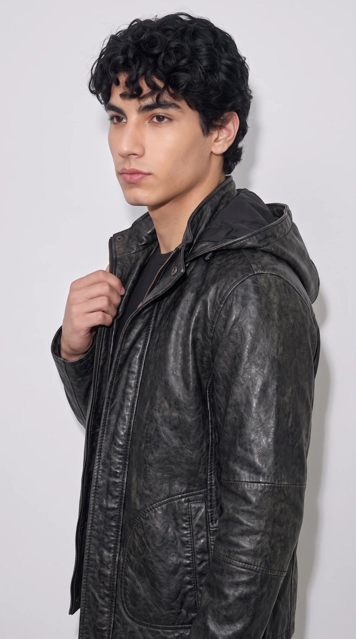Black vintage-washed leather jacket with an attached hood, full-length zip fastening, curved lower pockets and carefully stitched panels, creating a rugged utility-inspired look for casual outfits and cooler days.