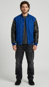 Jackero premium blue suede varsity jacket highlighting the striking contrast with black leather sleeves and button closure.