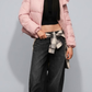 Model wearing a jackero high-end dusty rose pink quilted puffer jacket with a plush faux-fur trim hood, paired with black wide-leg denim jeans.