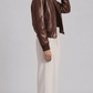 Dark brown leather jacket with crocodile texture detailing, front zip closure, and dark brown ribbed cuffs.