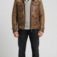 Versatile dark brown distressed leather field jacket layered over a casual outfit, blending heavy-duty utility with modern street style.